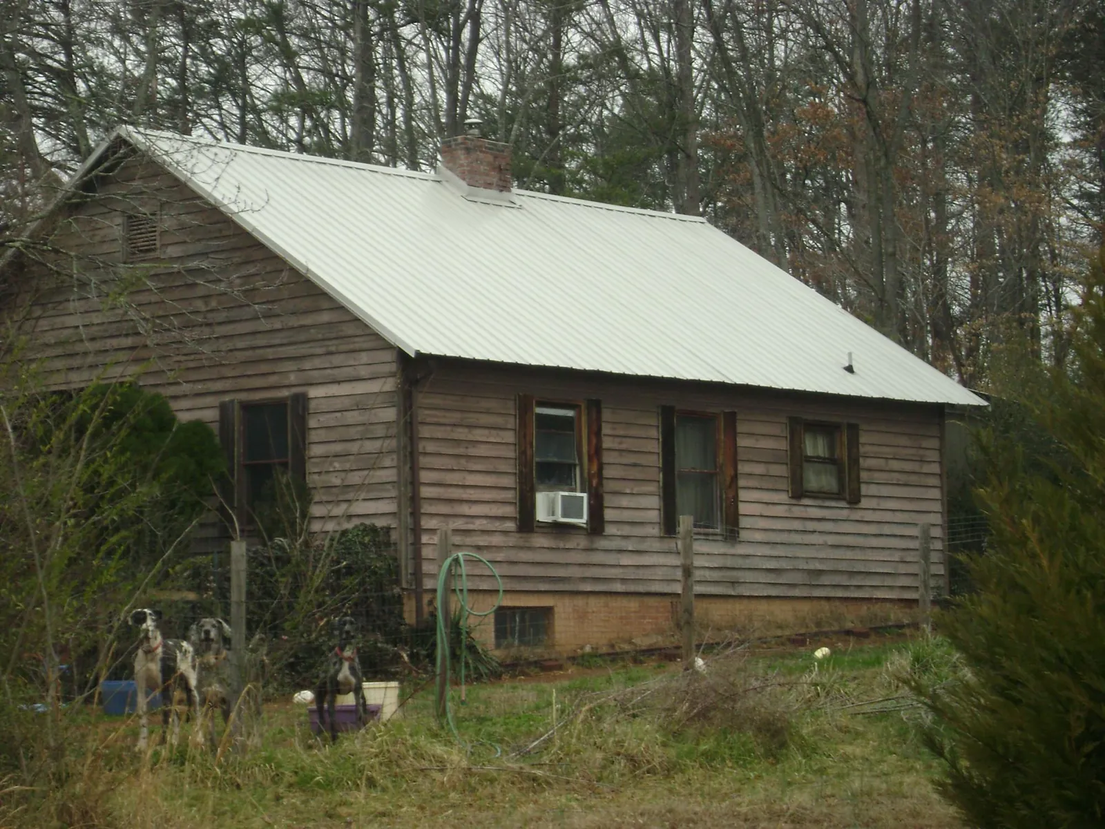 White metal roof on an old wood sided farmhouse, from a Asphalt Shingle Roof Repair job in Pleasant Valley